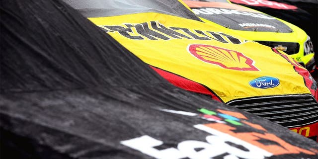 AVONDALE, AZ - NOVEMBER 15: Cars are seen covered on pit during a rain delay in the NASCAR Sprint Cup Series Quicken Loans Race for Heroes 500 at Phoenix International Raceway on November 15, 2015 in Avondale, Arizona. (Photo by Sean Gardner/Getty Images)