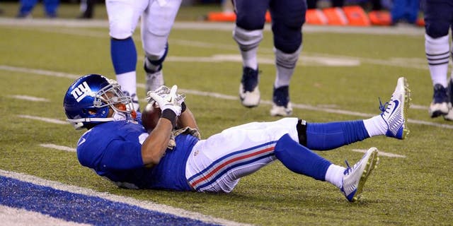 Nov 15, 2015; East Rutherford, NJ, USA; New York Giants cornerback Trumaine McBride (38) intercepts a pass against the New England Patriots during the game at MetLife Stadium. Mandatory Credit: Robert Deutsch-USA TODAY Sports