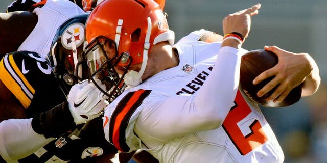 Cleveland Browns quarterback Johnny Manziel (2) is tackled by the face mask by Pittsburgh Steelers outside linebacker Arthur Moats (55) in the second quarter of an NFL football game, Sunday, Nov. 15, 2015, in Pittsburgh. Moats was penalized on the play. (AP Photo/Don Wright)