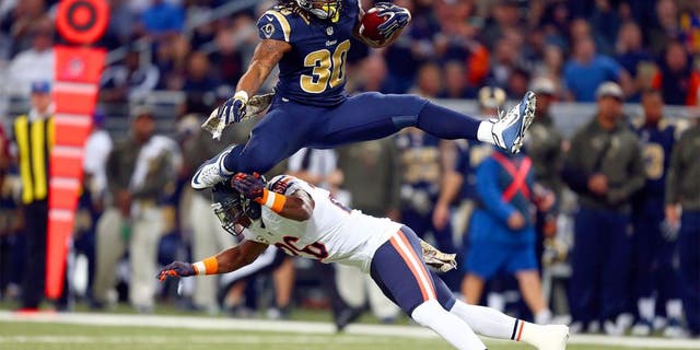 ST. LOUIS, MO - NOVEMBER 15: Todd Gurley #30 of the St. Louis Rams leaps over Antrel Rolle #26 of the Chicago Bears as he carries the ball in the first quarter at the Edward Jones Dome on November 15, 2015 in St. Louis, Missouri. (Photo by Dilip Vishwanat/Getty Images)