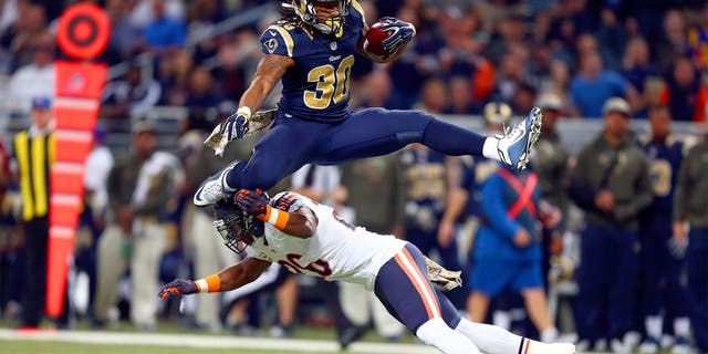 ST. LOUIS, MO - NOVEMBER 15: Todd Gurley #30 of the St. Louis Rams leaps over Antrel Rolle #26 of the Chicago Bears as he carries the ball in the first quarter at the Edward Jones Dome on November 15, 2015 in St. Louis, Missouri. (Photo by Dilip Vishwanat/Getty Images)