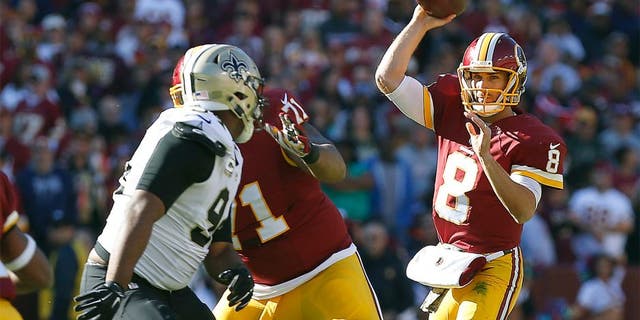 Nov 15, 2015; Landover, MD, USA; Washington Redskins quarterback Kirk Cousins (8) throws the ball over New Orleans Saints outside linebacker Kasim Edebali (91) in the first quarter at FedEx Field. Mandatory Credit: Geoff Burke-USA TODAY Sports