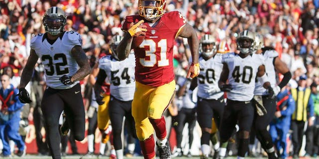 Washington Redskins running back Matt Jones (31) outpaces the New Orleans Saints defense to score a 78 yard touchdown during the first half of an NFL football game in Landover, Md., Sunday, Nov. 15, 2015. (AP Photo/Evan Vucci)