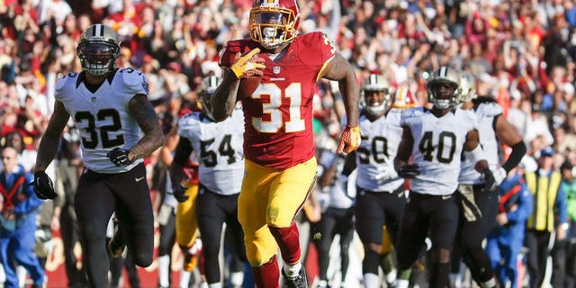 Washington Redskins running back Matt Jones (31) outpaces the New Orleans Saints defense to score a 78 yard touchdown during the first half of an NFL football game in Landover, Md., Sunday, Nov. 15, 2015. (AP Photo/Evan Vucci)