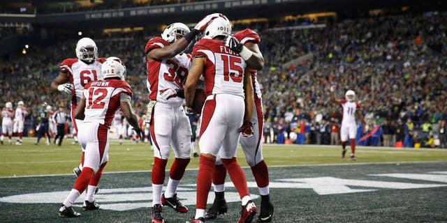 SEATTLE, WA - NOVEMBER 15: Michael Floyd #15 of the Arizona Cardinals celebrates with teammates in the end zone after scoring a touchdown during the second quarter against the Seattle Seahawks at CenturyLink Field on November 15, 2015 in Seattle, Washington. (Photo by Otto Greule Jr/Getty Images)