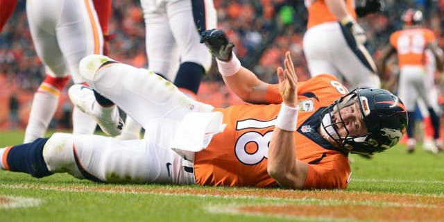 DENVER, CO - NOVEMBER 15: Peyton Manning (18) of the Denver Broncos is knocked down by Justin Houston (50) of the Kansas City Chiefs in the third quarter. The Broncos played the Kansas City Chiefs at Sports Authority Field at Mile High in Denver, CO on November 15, 2015. (Photo by Aaron Ontiveroz/The Denver Post via Getty Images)