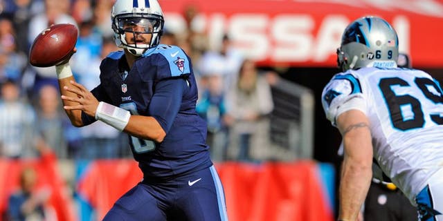 Nov 15, 2015; Nashville, TN, USA; Tennessee Titans quarterback Marcus Mariota (8) rolls out of the pocket chased by Carolina Panthers defensive end Jared Allen (69) during the first half at Nissan Stadium. Mandatory Credit: Christopher Hanewinckel-USA TODAY Sports
