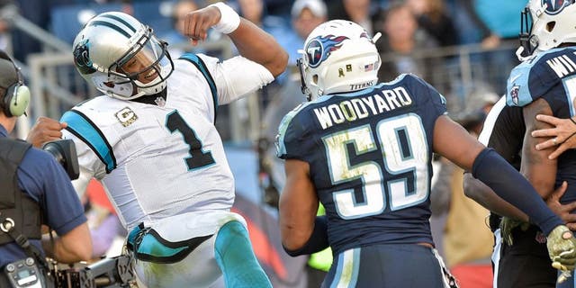 Nov 15, 2015; Nashville, TN, USA; Carolina Panthers quarterback Cam Newton (1) reacts in the end zone toward Tennessee Titans inside linebacker Wesley Woodyard (59) after scoring a touchdown during the second half at Nissan Stadium. Carolina won 27-10. Mandatory Credit: Jim Brown-USA TODAY Sports