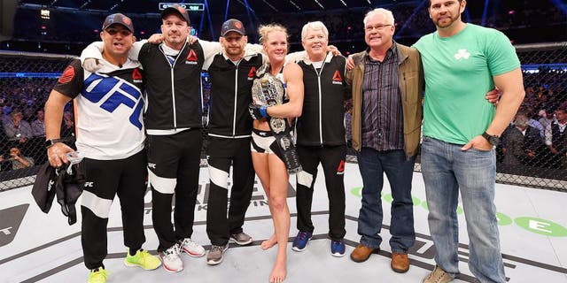 MELBOURNE, AUSTRALIA - NOVEMBER 15: Holly Holm celebrates with Team Holm after her second round KO (head kick and punches) against Ronda Rousey (not pictured) to win their UFC women's bantamweight championship bout during the UFC 193 event at Etihad Stadium on November 15, 2015 in Melbourne, Australia. (Photo by Josh Hedges/Zuffa LLC/Zuffa LLC via Getty Images)