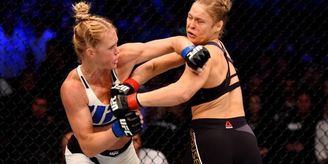 MELBOURNE, AUSTRALIA - NOVEMBER 15: Holly Holm (L) throws a left-handed punch against Ronda Rousey (R) in the first round of their UFC women's bantamweight championship bout during the UFC 193 event at Etihad Stadium on November 15, 2015 in Melbourne, Australia. (Photo by Josh Hedges/Zuffa LLC/Zuffa LLC via Getty Images)