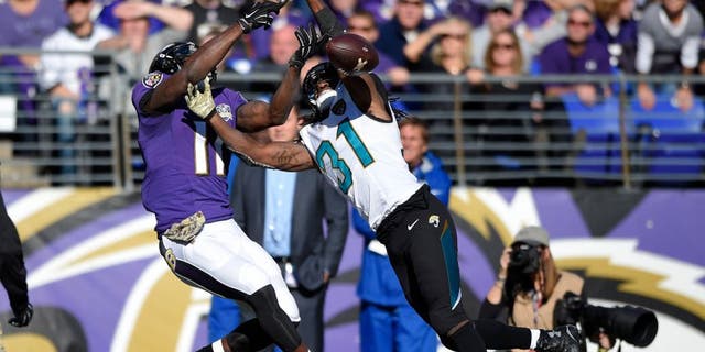 Jacksonville Jaguars cornerback Davon House, right, breaks up a pass-attempt to Baltimore Ravens wide receiver Kamar Aiken in the first half an NFL football game, Sunday, Nov. 15, 2015, in Baltimore. (AP Photo/Nick Wass)