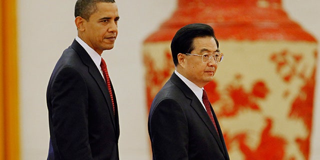 Nov. 17, 2010: President Obama walks with Chinese President Hu Jintao during a welcome ceremony at the Great Hall of the People in Beijing.