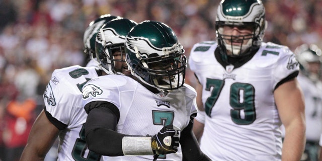 Nov. 15: Philadelphia Eagles quarterback Michael Vick (7) celebrates after scoring a rushing touchdown against the Washington Redskins during the first half of an NFL football game in Landover, Md.