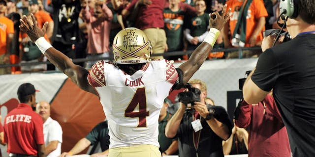 Nov 15, 2014; Miami Gardens, FL, USA; Florida State Seminoles running back Dalvin Cook (4) reacts after scoring a touchdown against the Miami Hurricanes during the second half at Sun Life Stadium. FSU won 30-26. Mandatory Credit: Steve Mitchell-USA TODAY Sports