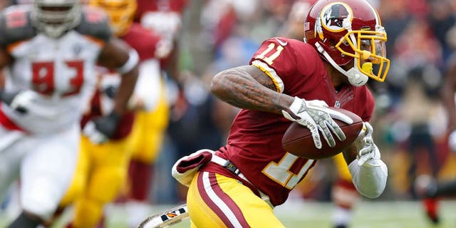 Nov 16, 2014; Landover, MD, USA; Washington Redskins wide receiver DeSean Jackson (11) runs with the ball as Tampa Bay Buccaneers defensive tackle Gerald McCoy (93) chases in the second quarter at FedEx Field. The Buccaneers won 27-7. Mandatory Credit: Geoff Burke-USA TODAY Sports