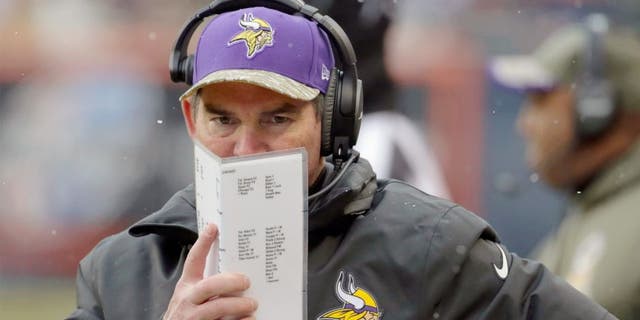 Minnesota Vikings head coach Mike Zimmer watches his team during the first half of an NFL football game against the Chicago Bears Sunday, Nov. 16, 2014 in Chicago. (AP Photo/Charles Rex Arbogast)