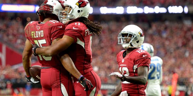 Nov 16, 2014; Glendale, AZ, USA; Arizona Cardinals receiver Michael Floyd (15) celebrates with receivers Larry Fitzgerald (11) and John Brown (12) after scoring on a 12-yard touchdown pass in the first quarter against the Detroit Lions at University of Phoenix Stadium. Mandatory Credit: Kirby Lee-USA TODAY Sports