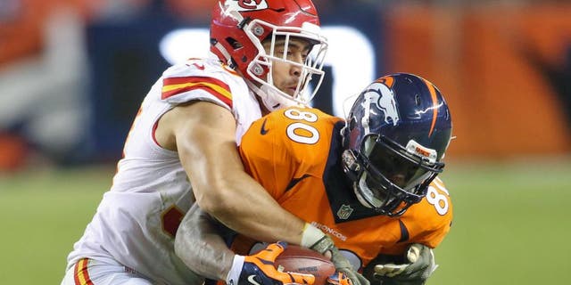 Nov 15, 2015; Denver, CO, USA; Denver Broncos tight end Vernon Davis (80) is brought down by Kansas City Chiefs inside linebacker Josh Mauga (90) during the second half at Sports Authority Field at Mile High. The Chiefs won 29-13. Mandatory Credit: Chris Humphreys-USA TODAY Sports