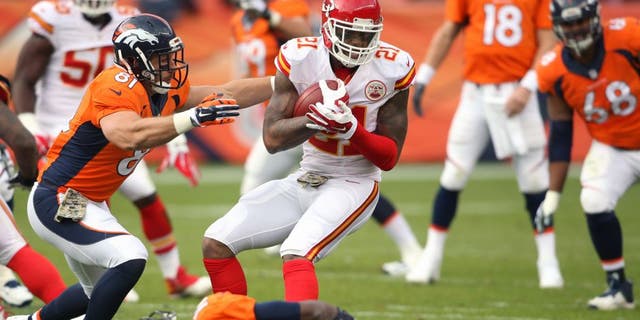 Nov 15, 2015; Denver, CO, USA; Kansas City Chiefs cornerback Sean Smith (21) attempts to avoid being tackled by Denver Broncos tight end Owen Daniels (81) and wide receiver Emmanuel Sanders (10) after intercepting a pass throw by Denver Broncos quarterback Peyton Manning (18) during the first half at Sports Authority Field at Mile High. Mandatory Credit: Chris Humphreys-USA TODAY Sports