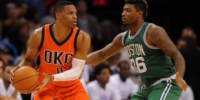 Nov 15, 2015; Oklahoma City, OK, USA; Oklahoma City Thunder guard Russell Westbrook (0) handles the ball while being guarded by Boston Celtics guard Marcus Smart (36) during the third quarter at Chesapeake Energy Arena. Mandatory Credit: Mark D. Smith-USA TODAY Sports