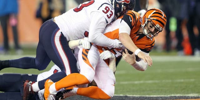 CINCINNATI, OH - NOVEMBER 16: Andy Dalton #14 of the Cincinnati Bengals is tackled by Benardrick McKinney #55 of the Houston Texans and Jared Crick #93 of the Houston Texans during the second quarter at Paul Brown Stadium on November 16, 2015 in Cincinnati, Ohio. (Photo by John Grieshop/Getty Images)