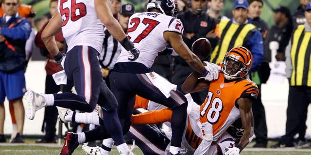 Nov 16, 2015; Cincinnati, OH, USA; Cincinnati Bengals wide receiver A.J. Green (18) fights for the ball with Houston Texans strong safety Quintin Demps (27) after fumbling the ball in the second half at Paul Brown Stadium. The Texans won 10-6. Mandatory Credit: Aaron Doster-USA TODAY Sports