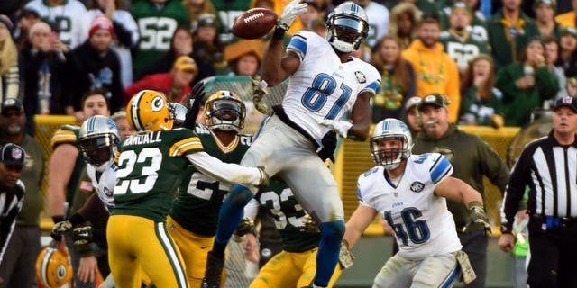 Nov 15, 2015; Green Bay, WI, USA; Green Bay Packers cornerback Damarious Randall (23) recovers an onside kick as the ball bounces off the hands of Detroit Lions wide receiver Calvin Johnson (81) in the fourth quarter at Lambeau Field. Mandatory Credit: Benny Sieu-USA TODAY Sports
