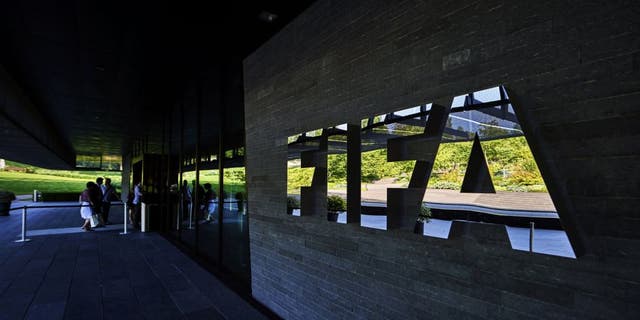 FIFA employees enter at the FIFA headquarters on June 3, 2015 in Zurich. Blatter resigned on June 2, 2015 as president of FIFA as a mounting corruption scandal engulfed world football's governing body. The 79-year-old Swiss official, FIFA president for 17 years and only reelected on May 29, said a special congress would be called as soon as possible to elect a successor. AFP PHOTO / MICHAEL BUHOLZER (Photo credit should read MICHAEL BUHOLZER/AFP/Getty Images)