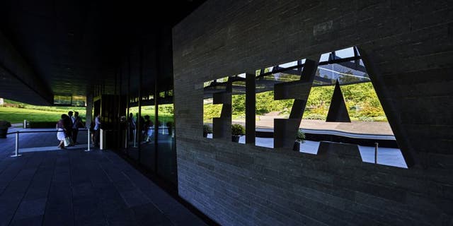 FIFA employees enter at the FIFA headquarters on June 3, 2015 in Zurich. Blatter resigned on June 2, 2015 as president of FIFA as a mounting corruption scandal engulfed world football's governing body. The 79-year-old Swiss official, FIFA president for 17 years and only reelected on May 29, said a special congress would be called as soon as possible to elect a successor. AFP PHOTO / MICHAEL BUHOLZER (Photo credit should read MICHAEL BUHOLZER/AFP/Getty Images)