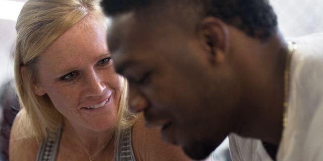 ALBUQUERQUE, NM - OCTOBER 31: (L-R) Holly Holm and Jon Jones sign autographs for fans during the Jackson Wink MMA Academy Grand Opening at Jackson's Mixed Martial Arts & Fitness on October 31, 2015 in Albuquerque, New Mexico. (Photo by Brandon Magnus/Zuffa LLC/Zuffa LLC via Getty Images)