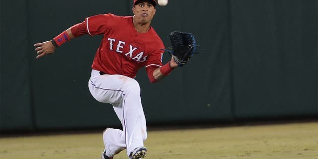 ARLINGTON, TX - SEPTEMBER 27: Leonys Martin #2 of the Texas Rangers makes a running catch hit by Alberto Callaspo of the Oakland Athletics in the seventh inning at Globe Life Park in Arlington on September 27, 2014 in Arlington, Texas. (Photo by Rick Yeatts/Getty Images)