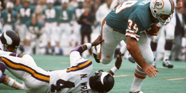 Larry Csonka (39) of the Miami Dolphins runs through the tackle of Nate Wright (43) of the Minnesota Vikings during Super Bowl VIII at Rice Stadium, Jan. 13, 1974, in Houston, Texas. The Dolphins won the Super Bowl 24-7. (Focus on Sport/Getty Images)