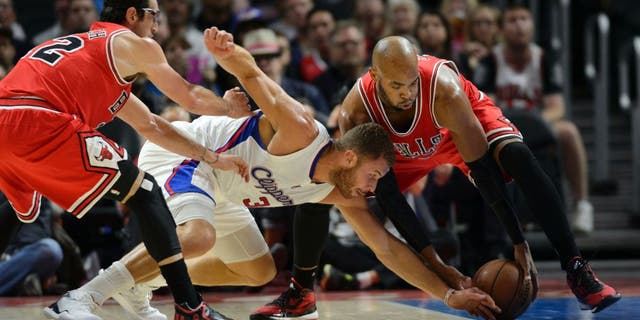 Nov 17, 2014; Los Angeles, CA, USA; Los Angeles Clippers forward Blake Griffin (32) and Chicago Bulls forward Taj Gibson (22) battle for the loose ball during the first quarter at Staples Center. Mandatory Credit: Kelvin Kuo-USA TODAY Sports