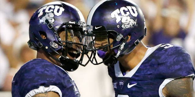 FORT WORTH, TX - SEPTEMBER 19: (L-R) Trevone Boykin #2 of the TCU Horned Frogs celebrates with teammate Josh Doctson #9 after Boykin scored on a touchdown run in the second quarter against the Southern Methodist Mustangs at Amon G. Carter Stadium on September 19, 2015 in Fort Worth, Texas. (Photo by Ron Jenkins/Getty Images)