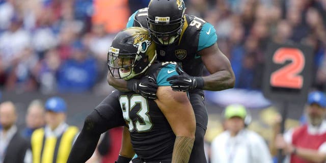 Oct 25, 2015; London, United Kingdom; Jacksonville Jaguars defensive end Tyson Alualu (93) celebrates with defensive end Chris Clemons (91) after a sack in the first quarter against the Buffalo Bills during NFL International Series game at Wembley Stadium. Mandatory Credit: Kirby Lee-USA TODAY Sports