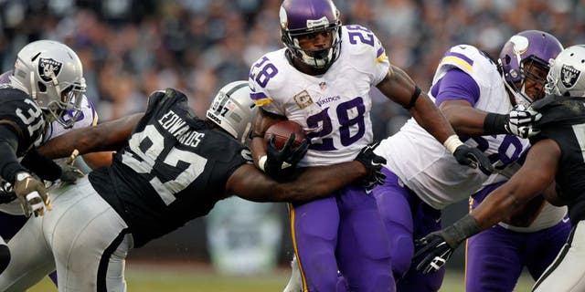 Nov 15, 2015; Oakland, CA, USA; Minnesota Vikings running back Adrian Peterson (28) runs the ball against the Oakland Raiders in the fourth quarter at O.co Coliseum. The Vikings defeated the Raiders 30-14. Mandatory Credit: Cary Edmondson-USA TODAY Sports