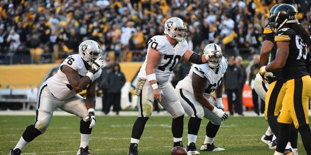 PITTSBURGH, PA - NOVEMBER 8: Center Tony Bergstrom #70 of the Oakland Raiders signals at the line of scrimmage as guards J'Marcus Webb #76 and Gabe Jackson #66 look on during a game against the Pittsburgh Steelers at Heinz Field on November 8, 2015 in Pittsburgh, Pennsylvania. The Steelers defeated the Raiders 38-35. (Photo by George Gojkovich/Getty Images)