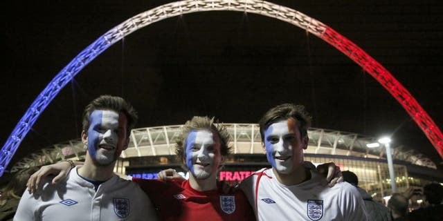 LONDON, ENGLAND - NOVEMBER 17: Football fans with their faces painted in the colors of Frenc flag are seen outside of Wembley Stadium, before the start of the friendly football match between England and France at Wembley Stadium in west London on November 17, 2015. (Photo by Yunus Kaymaz/Anadolu Agency/Getty Images)