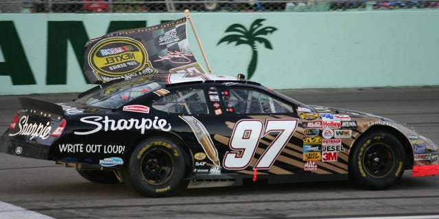 HOMESTEAD, FL - NOVEMBER 21: Kurt Busch, driver of the #97 Roush Racing Sharpie Ford, celebrates after winning the NASCAR Nextel Cup Series Championship at the Ford 400 on November 21, 2004 at the Homestead Miami Speedway in Homestead, Florida. (Photo by Robert Laberge/Getty Images)