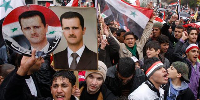 November 16, 2011: Pro-Syrian regime protesters, shout pro-Syrian President Bashar Assad slogans during a demonstration in Damascus, Syria.