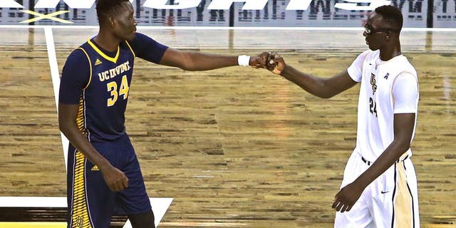 ORLANDO, FL - NOVEMBER 18: Mamadou Ndiaye #34 of the UC Irvine Anteaters (L) and Tacko Fall #24 of the UCF Knights bump fists with each other at half court prior to tipoff of an NCAA basketball game between the California-Irvine Anteaters and the UCF Knights at the CFE Arena on November 18, 2015 in Orlando, Florida. California-Irvine won the game 61-60 in overtime. (Photo by Alex Menendez/Getty Images)