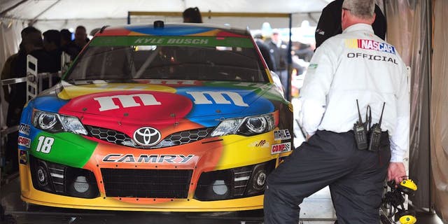 MARTINSVILLE, VA - MARCH 28: The #18 M&M's Toyota, driven by Kyle Busch, goes through technical inspection during qualifying for the NASCAR Sprint Cup Series STP 500 at Martinsville Speedway on March 28, 2014 in Martinsville, Virginia. (Photo by Jeff Curry/Getty Images)