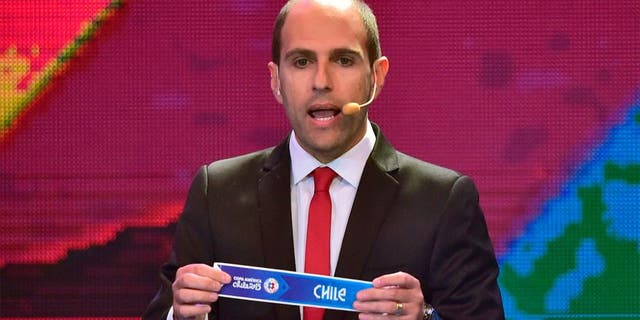 The president of Chile's Professional Football National Association (ANFP) Sergio Jadue, shows the name of Chile during the Copa America 2015 draw, at the Quinta Vergara in Vina del Mar, Chile, on November 24, 2014. The Copa America Chile 2015 will take place in eight Chilean cities, from June 11 to July 4, 2015. AFP PHOTO / MARTIN BERNETTI (Photo credit should read MARTIN BERNETTI/AFP/Getty Images)