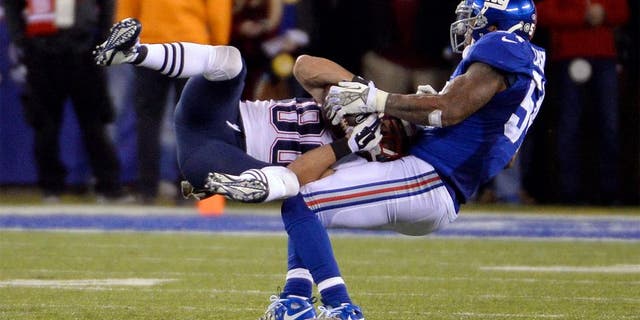 Nov 15, 2015; East Rutherford, NJ, USA; New England Patriots wide receiver Danny Amendola (80) catches a pass against New York Giants outside linebacker Jonathan Casillas (54) during the game at MetLife Stadium. Mandatory Credit: Robert Deutsch-USA TODAY Sports