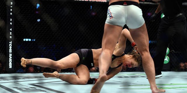 MELBOURNE, AUSTRALIA - NOVEMBER 15: (L-R) Ronda Rousey falls to the mat as she is knocked out by Holly Holm in their UFC women's bantamweight championship bout during the UFC 193 event at Etihad Stadium on November 15, 2015 in Melbourne, Australia. (Photo by Jeff Bottari/Zuffa LLC/Zuffa LLC via Getty Images)