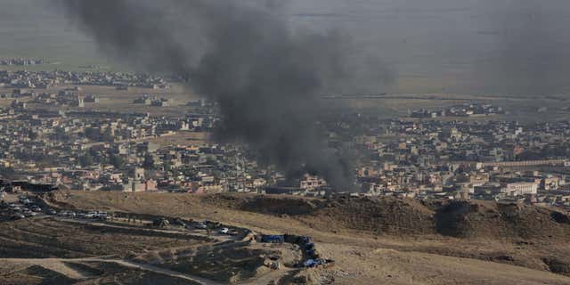 Nov. 12, 2015: Smoke rises over Sinjar, northern Iraq from oil fires set by Islamic State militants as Kurdish Iraqi fighters, backed by U.S.-led airstrikes, launch a major assault.