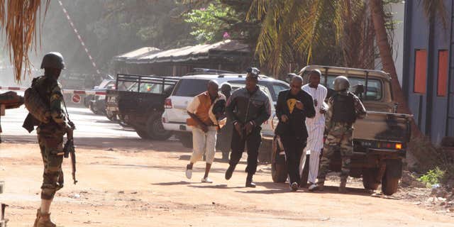 Nov. 20, 2015: People run to flee from the Radisson Blu Hotel in Bamako, Mali.