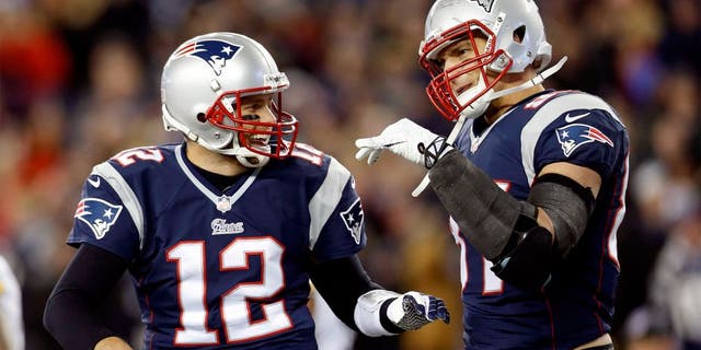 Nov 3, 2013; Foxborough, MA, USA; New England Patriots quarterback Tom Brady (12) congratulates tight end Rob Gronkowski (87) on scoring a touchdown during the second quarter against the Pittsburgh Steelers at Gillette Stadium. Mandatory Credit: Greg M. Cooper-USA TODAY Sports