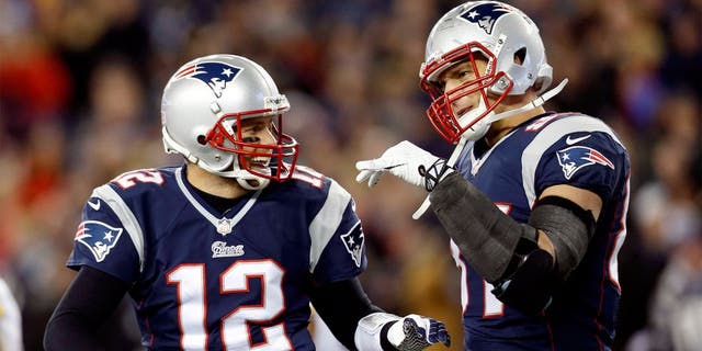 Nov 3, 2013; Foxborough, MA, USA; New England Patriots quarterback Tom Brady (12) congratulates tight end Rob Gronkowski (87) on scoring a touchdown during the second quarter against the Pittsburgh Steelers at Gillette Stadium. Mandatory Credit: Greg M. Cooper-USA TODAY Sports