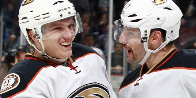 VANCOUVER, BC - NOVEMBER 20: Ryan Kesler #17 congratulates Jakob Silfverberg #33 of the Anaheim Ducks who scored the shootout winning goal against the Vancouver Canucks during their NHL game at Rogers Arena November 20, 2014 in Vancouver, British Columbia, Canada. Anaheim won 4-3 in a shootout. (Photo by Jeff Vinnick/NHLI via Getty Images)